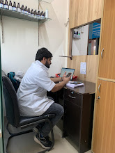 A TB expert reviewing patient reports at the clinic